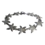 A silver bracelet modelled as starfish forms