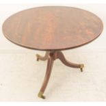 An early 19th century circular tilt-top mahogany occasional table: the one-piece top of good colour,
