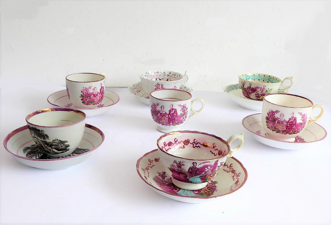 Six early to mid 19th century Sunderland lustre commemorative cups and saucers, and one cup: 1817