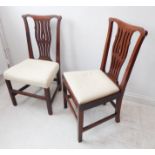 A pair of 18th century walnut side chairs; shaped top rails, pierced splats, overstuffed seats and