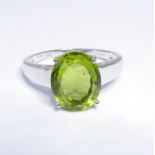 A 9-carat gold ring set with a green peridot, ring size P/Q (boxed)
