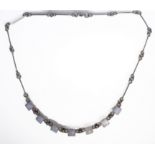 A silver necklace set with seven mounted polished hardstones/agates