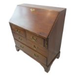 A late 18th century mahogany writing bureau: the angular fall opening to reveal fitted interior with