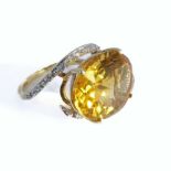 A 10-carat gold ring set with a large citrine and diamond chips, ring size L/M (boxed)