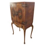 A mid 20th century figured walnut veneered drinks cabinet in late 17th century style: two doors