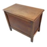 A mid 20th century oak chest: thumbnail moulded hinged top above panelled sides, raised on stile