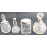 19th century cut glassware comprising three silver-mounted scent bottles and a lady's circular cut-