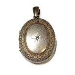 An oval gold locket set with a small diamond (10.7g)