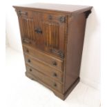 A good reproduction oak side cabinet/chest: the two upper doors with blacksmith-style iron handles
