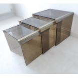 A nest of three modern Designer smoked-glass and gilt-metal mounted (rubbed) occasional tables (