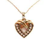 A lady's heavy silver gilt heart-shaped crossover style pendant mounted with twelve diamonds (the