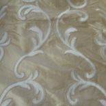 A pair of curtains in champagne silk decorated with machine embroidery from Colefax & Fowler; goblet