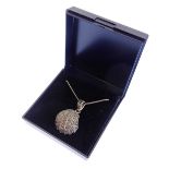 A scallop-shell-shaped Art-Deco-style silver marquisate-mounted pendant on a silver chain (boxed)