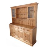 A large 19th century style (good reproduction) pine dresser: the outset cornice above central