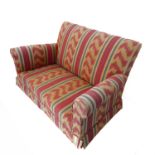 A brightly upholstered two-seater sofa with reds, creams, greens, blues etc. (133cm wide x 90cm deep