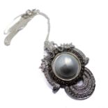 An 18-carat white gold pendant centred with a large mabé pearl surrounded by champagne diamonds