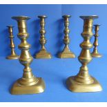 Three pairs of 19th century brass candlesticks (two pairs with ejector sticks) (the tallest 24.5cm)