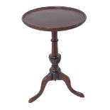 A Georgian style (reproduction) mahogany wine table: dished-top above turned stem and tripod base