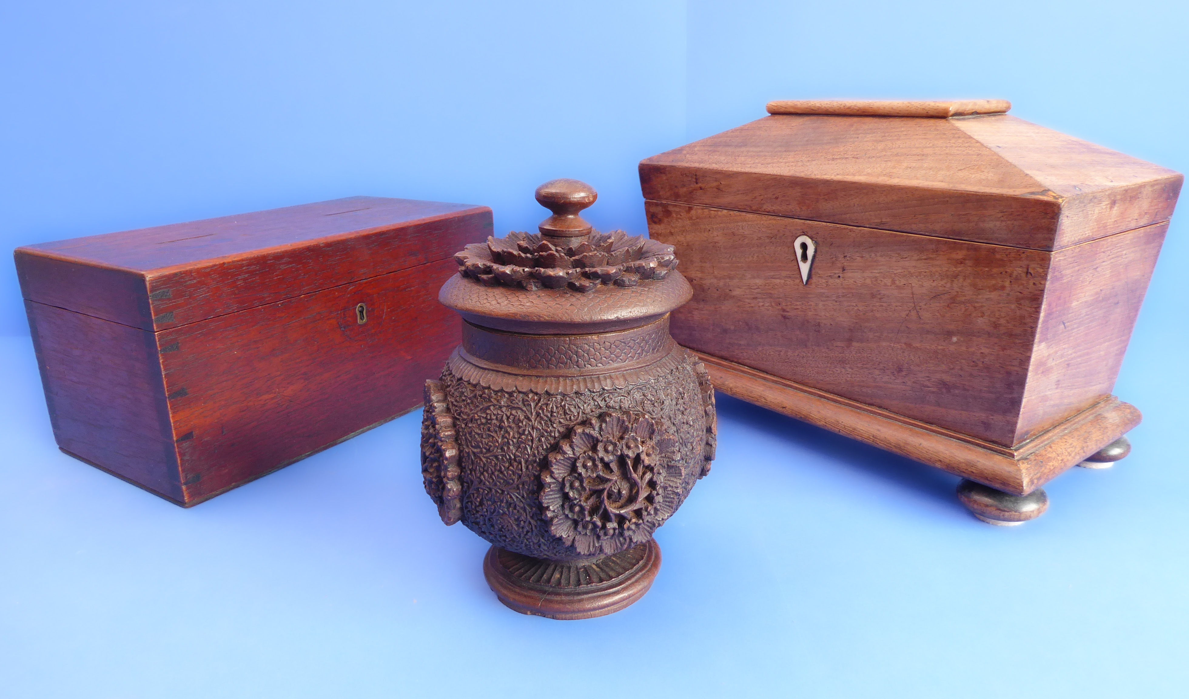 An early 19th century sarcophagus-shaped two-division faded rosewood tea caddy, together with a 19th