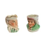 A pair of 19th century Staffordshire Punch and Judy jugs (11 cm high)