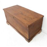 An early to mid 19th century elm chest: the lid with strap hinges above short bracket feet (83cm