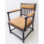 An early 20th century stained wood open armchair: stuffover top rail above barley-twist verticals,