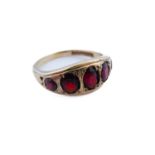 A 9-carat gold gipsy-style ring set with five graduated garnets, ring size R/S