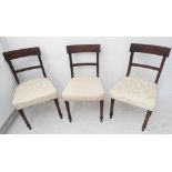 A set of three early 19th century Regency period mahogany salon chairs: each with concave tablet