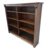 A good early 20th century solid oak bookcase: the slightly overhanging reeded top above half-