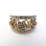 A 9-carat gold dress ring set with small tanzanites and diamonds (boxed), ring size K/L