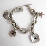 An unusual bracelet set with various charms and signed 'Danon'