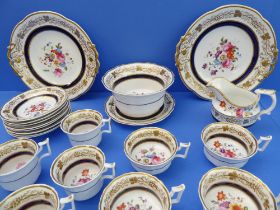 A 19th century part tea service hand-gilded and decorated in enamels with floral sprays:  2 x 25