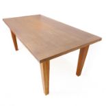 A modern solid oak kitchen-style table: the planked top with cleated ends and showing medullary