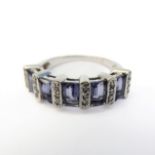 A 9-carat white gold ring set with five baguette tanzanite stones and diamonds (boxed), ring size M