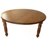 A large circular farmhouse-style pine table with three turned legs (151cm diameter x 78cm high)
