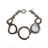A silver bracelet modelled as angular concentric circles