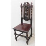 A late 19th century carved oak hall-style chair: the pierced vertical splats decorated in relief