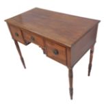 A William IV period mahogany and crossbanded writing table: central drawer with two carved fan