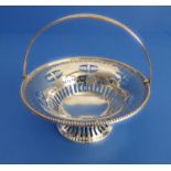 A pierced hallmarked silver bonbon dish with swing-handle and of circular form, marks of