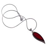 An unusual silver mounted and red hardstone inverted teardrop-shaped pendant upon a silver chain, in