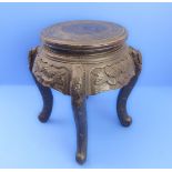An early 20th century Chinese ebonised carved wood  jardinière stand of small proportions:
