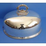 A large late 19th century dome-shaped silver-plated meat cover with gadrooned edge (dent to one end)