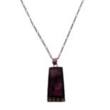 An unusual silver pendant of tapering rectangular form and mounted with a dark amethyst-style