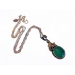 A silver pendant mounted with a green hardstone polished en cabochon, upon a silver chain (boxed)