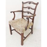 An 18th century style (later reproduction) open arm mahogany ladderback carver chair of generous