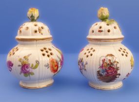 A pair of late 19th century Dresden-style potpourris of baluster form: each cover with flowerhead