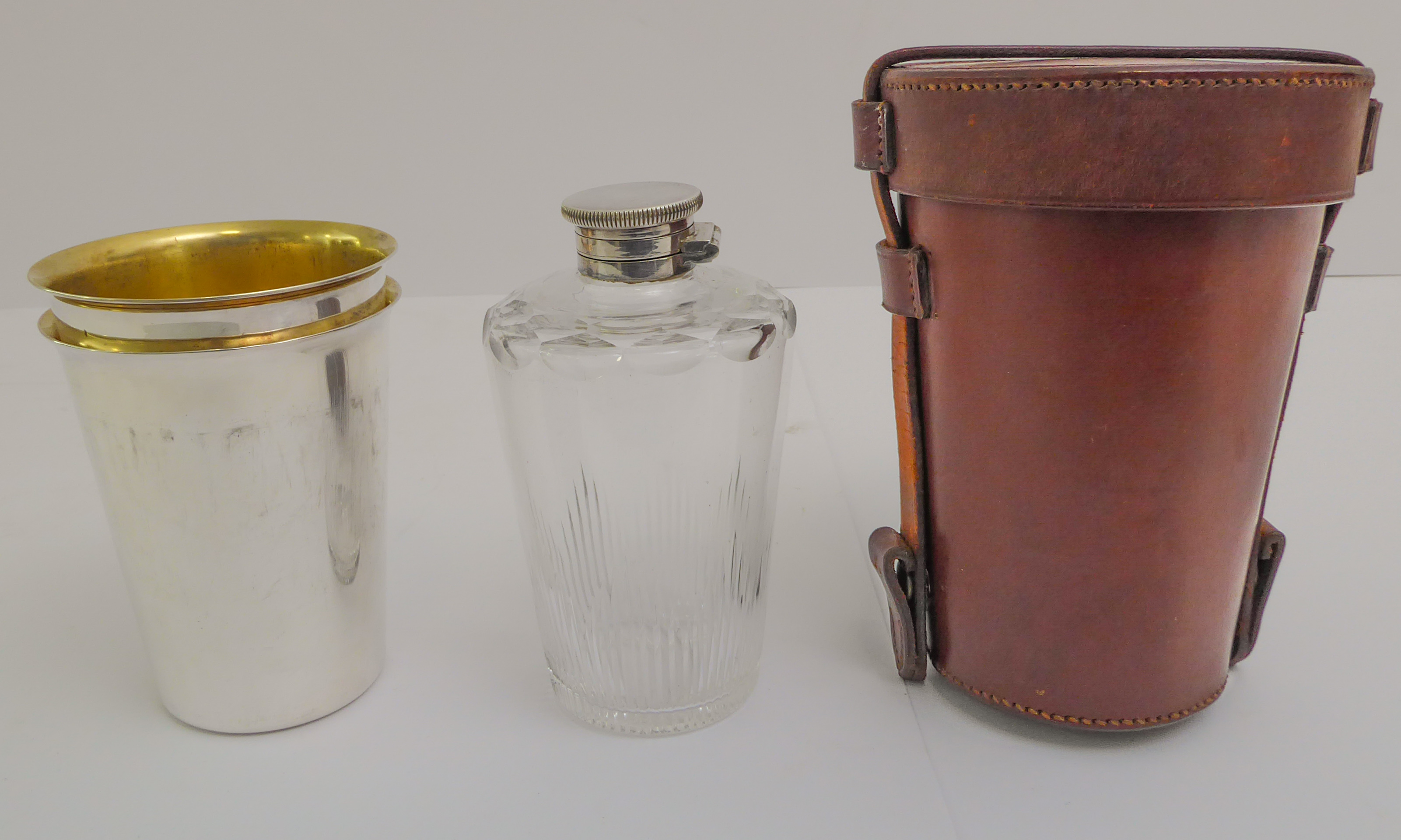 A leather-cased silver-plate and finely cut glass travel flask with two matched silver-plated,