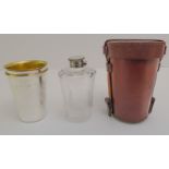 A leather-cased silver-plate and finely cut glass travel flask with two matched silver-plated,