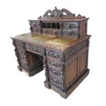 A large and profusely carved 19th century oak desk: the galleried top carved with scrolling acanthus