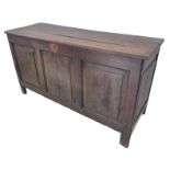 A large early 18th century oak chest: moulded three-plank top opening to reveal left-hand candle-